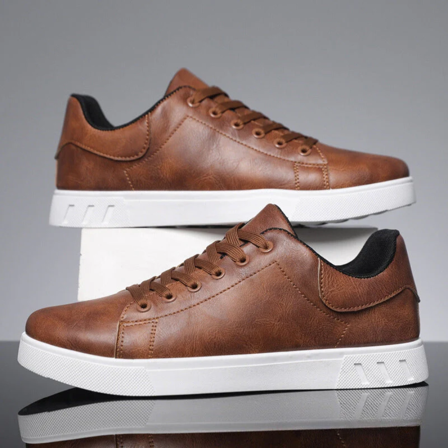 Men's low-top lace-up sneaker with stitched panels and white flat sole