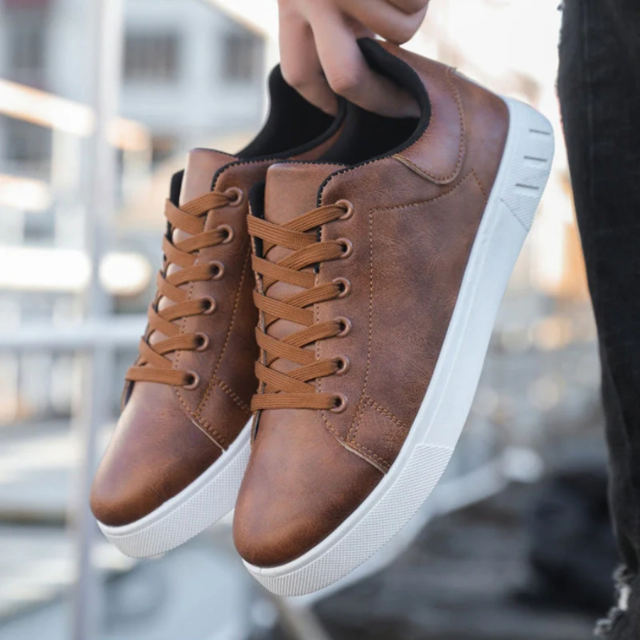 Men's low-top lace-up sneaker with stitched panels and white flat sole