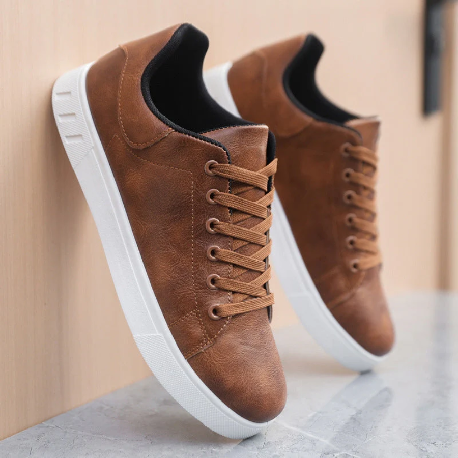 Men's low-top lace-up sneaker with stitched panels and white flat sole