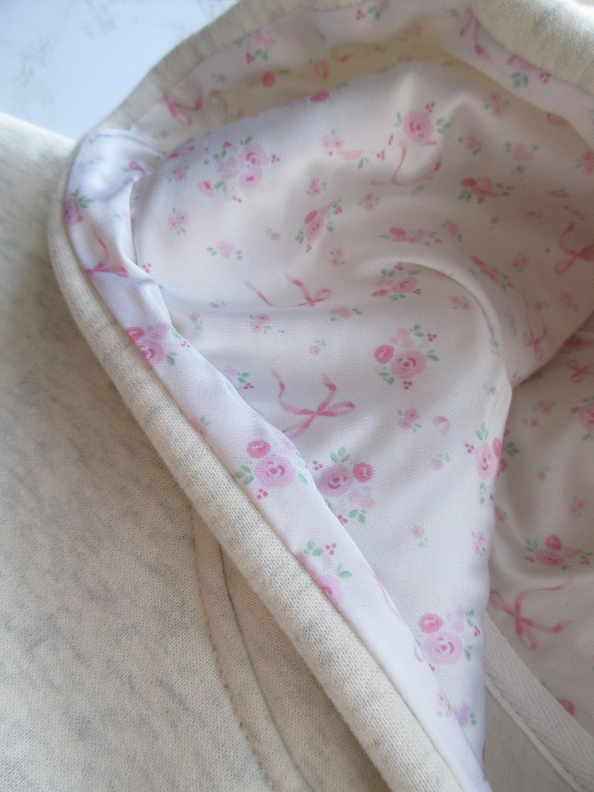 Light gray oversized hoodie with pink bow embroidery and floral hood lining