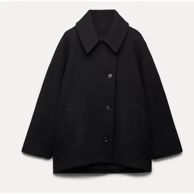 Women's oversized coat with point collar, button front and two welt pockets