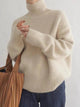 Women's ribbed knit turtleneck pullover in cream with long sleeves