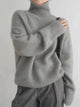 Women's ribbed knit turtleneck pullover in cream with long sleeves