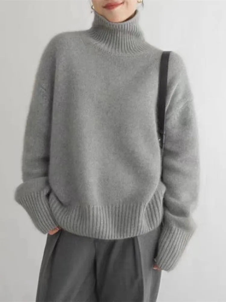Women's ribbed knit turtleneck pullover in cream with long sleeves