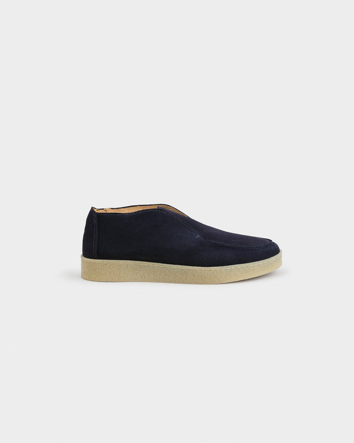 Men's navy moc toe ankle boots with slip-on opening and flat contrasting soles