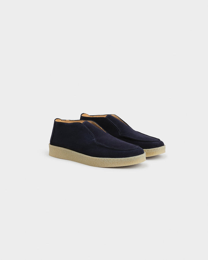 Men's navy moc toe ankle boots with slip-on opening and flat contrasting soles