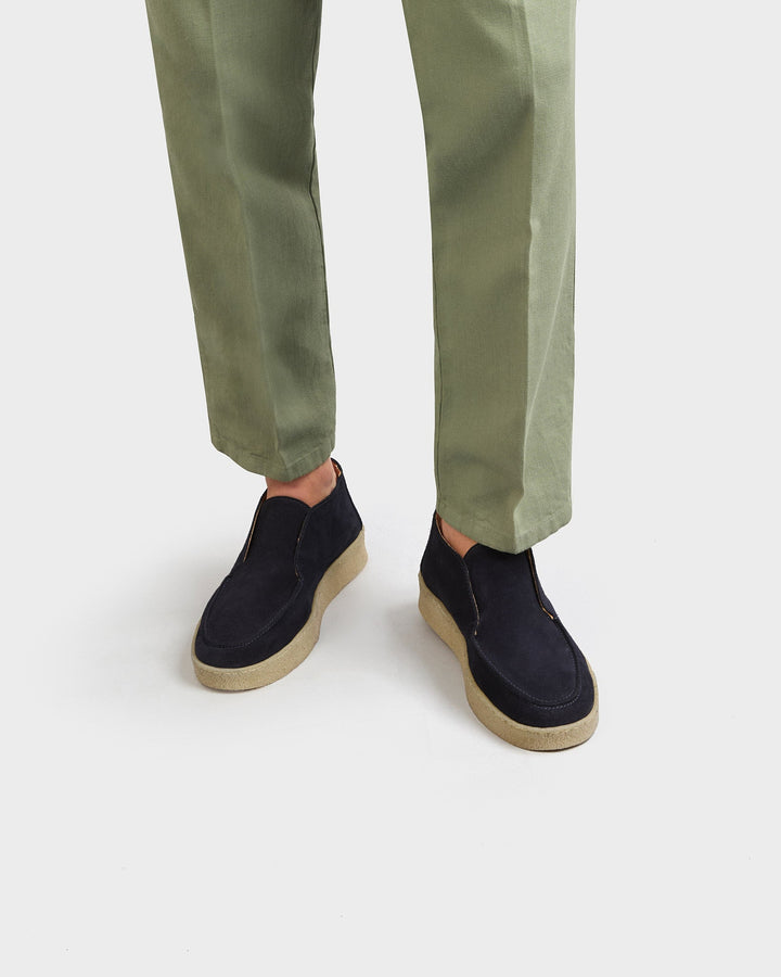 Men's navy moc toe ankle boots with slip-on opening and flat contrasting soles