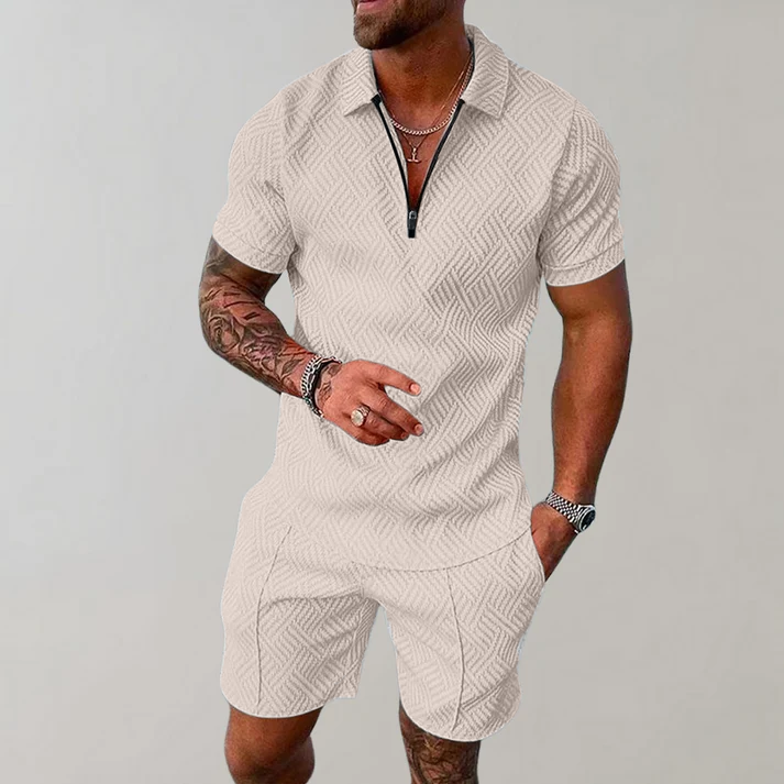 Man wearing a quarter-zip short-sleeve polo in a textured geometric knit with matching shorts