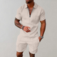 Man wearing a quarter-zip short-sleeve polo in a textured geometric knit with matching shorts