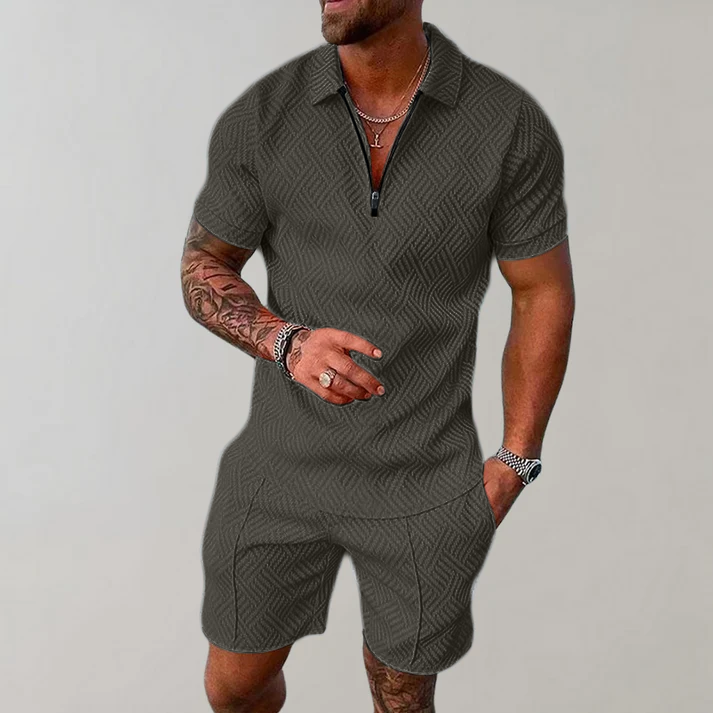 Man wearing a quarter-zip short-sleeve polo in a textured geometric knit with matching shorts