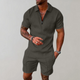 Man wearing a quarter-zip short-sleeve polo in a textured geometric knit with matching shorts