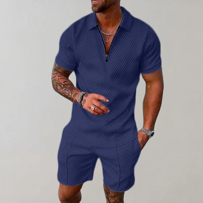 Man wearing a quarter-zip short-sleeve polo in a textured geometric knit with matching shorts