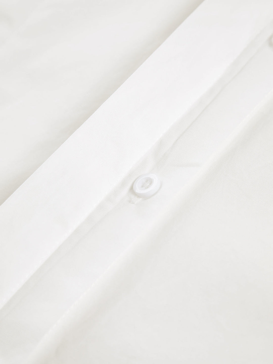 Women's white button-up shirt with wide cuffs and pointed collar, long sleeves