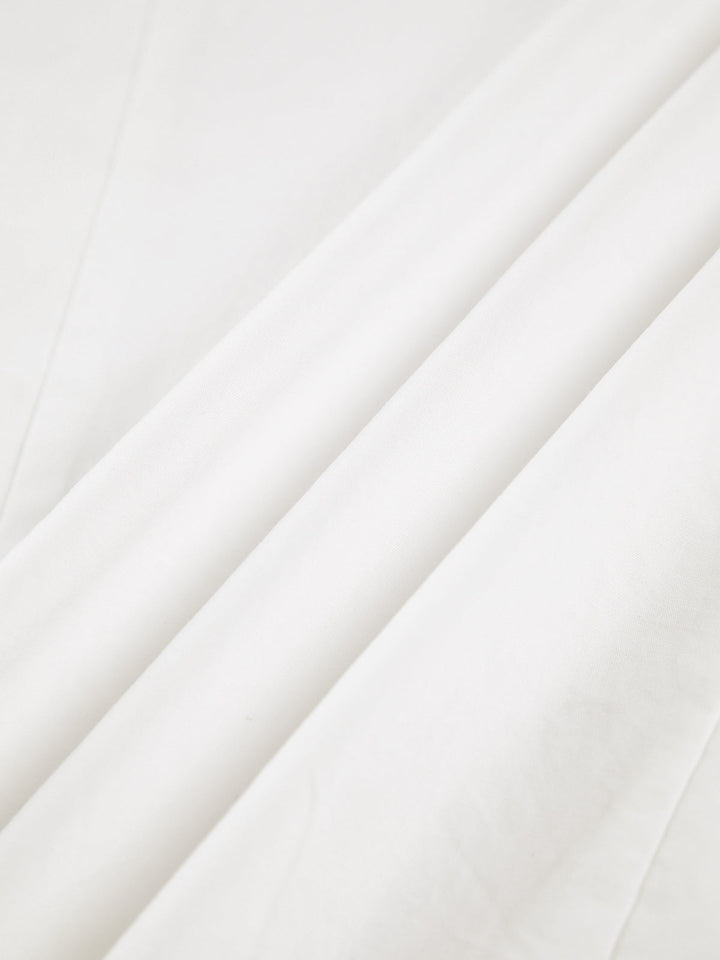 Women's white button-up shirt with wide cuffs and pointed collar, long sleeves