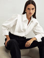 Women's white button-up shirt with wide cuffs and pointed collar, long sleeves