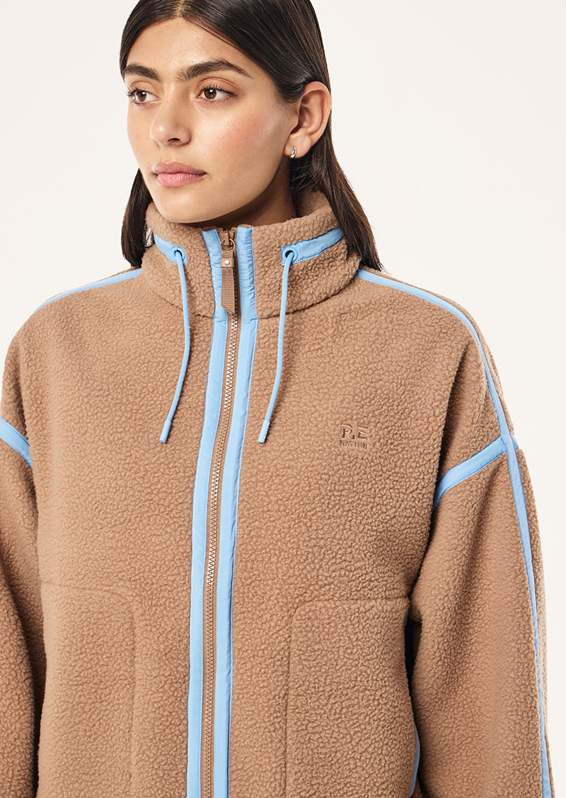 Women's brown sherpa jacket with blue contrast trim and hood
