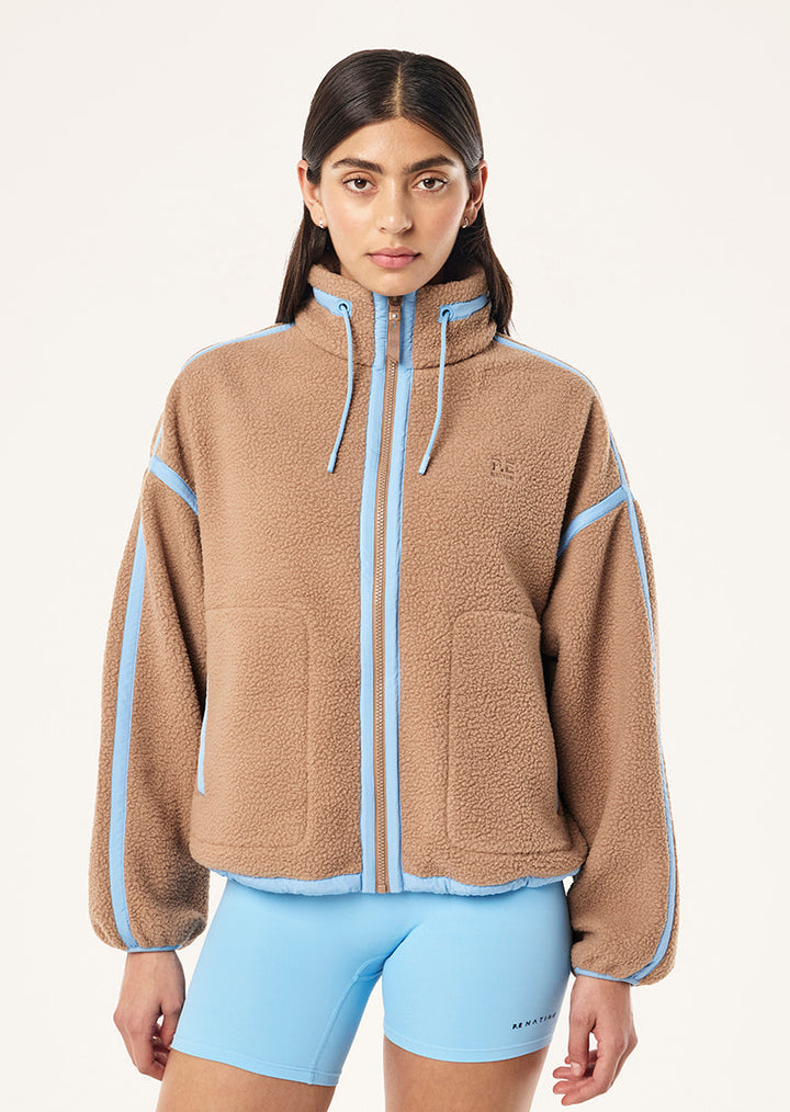 Women's brown sherpa jacket with blue contrast trim and hood
