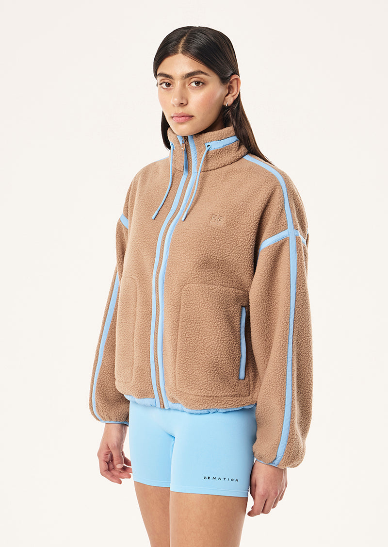 Women's brown sherpa jacket with blue contrast trim and hood