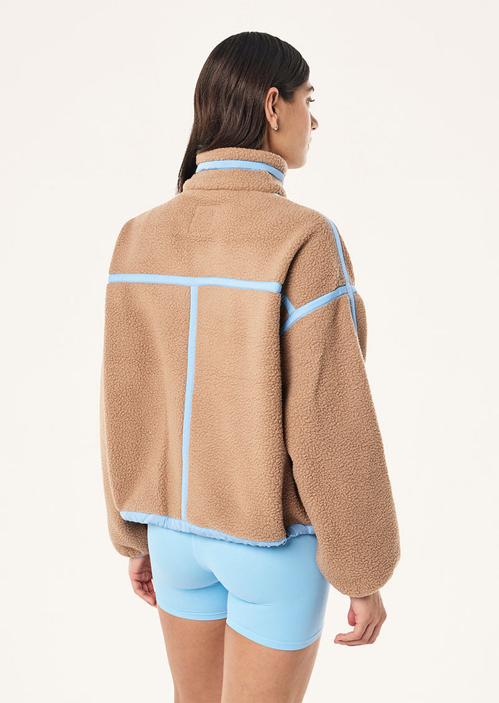 Women's brown sherpa jacket with blue contrast trim and hood