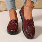 Women's round-toe moccasin loafers with bow detail and flat scalloped soles