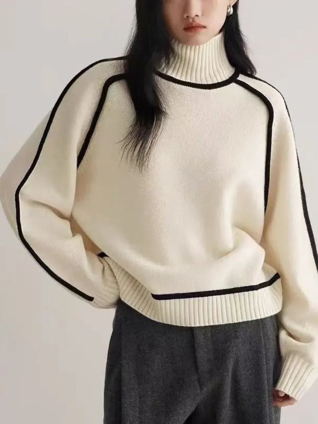 Women's oversized turtleneck sweater with contrast piping and long sleeves