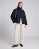 Women's navy short coat with stand collar, long sleeves and button front