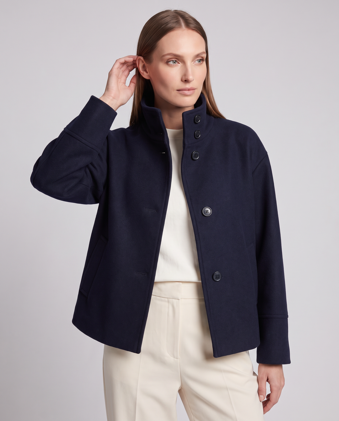 Women's navy short coat with stand collar, long sleeves and button front