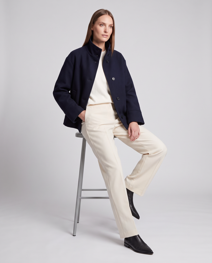 Women's navy short coat with stand collar, long sleeves and button front