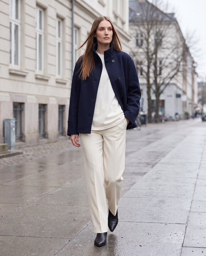 Women's navy short coat with stand collar, long sleeves and button front