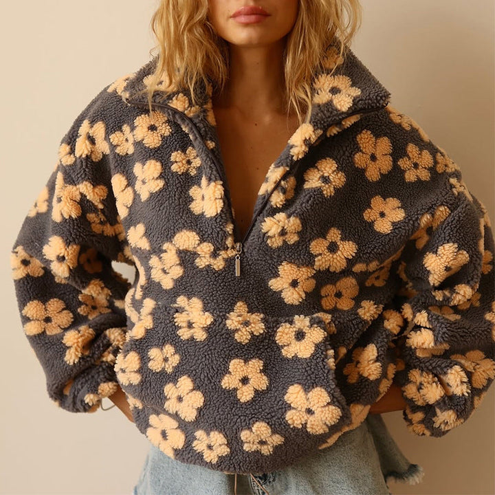 Women's floral fleece pullover with half-zip collar and front pocket
