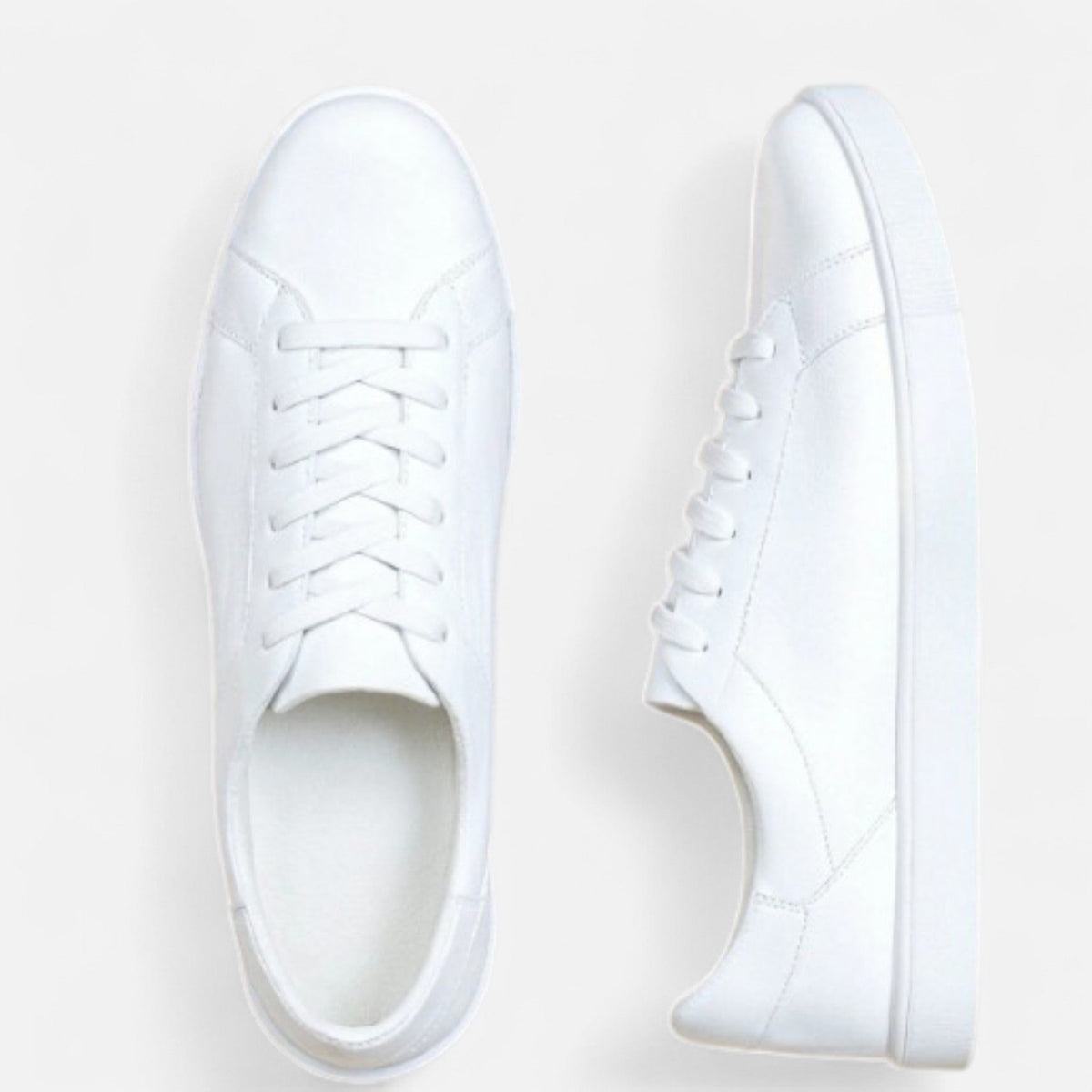Men's white low-top lace-up sneakers with round toes and flat soles