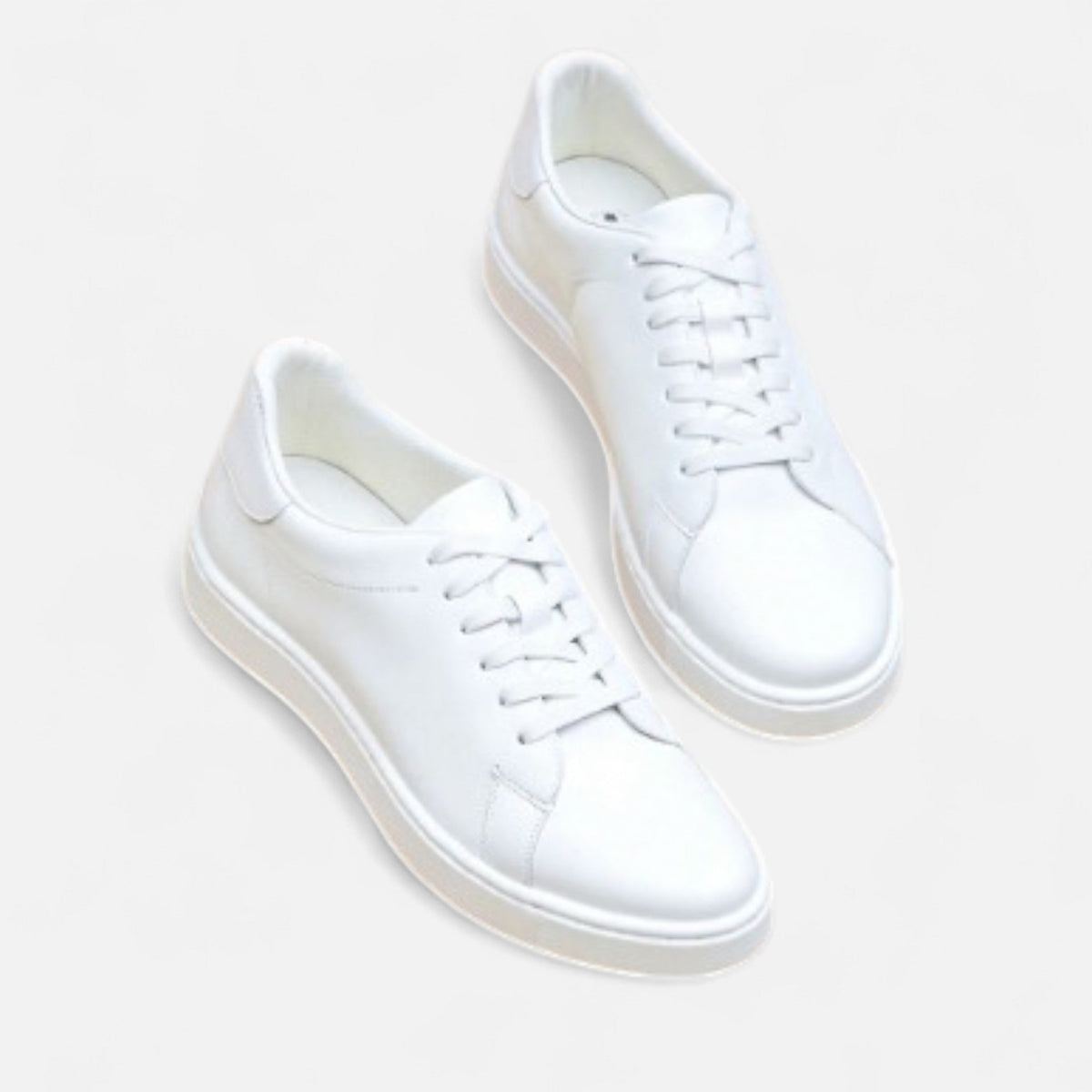 Men's white low-top lace-up sneakers with round toes and flat soles
