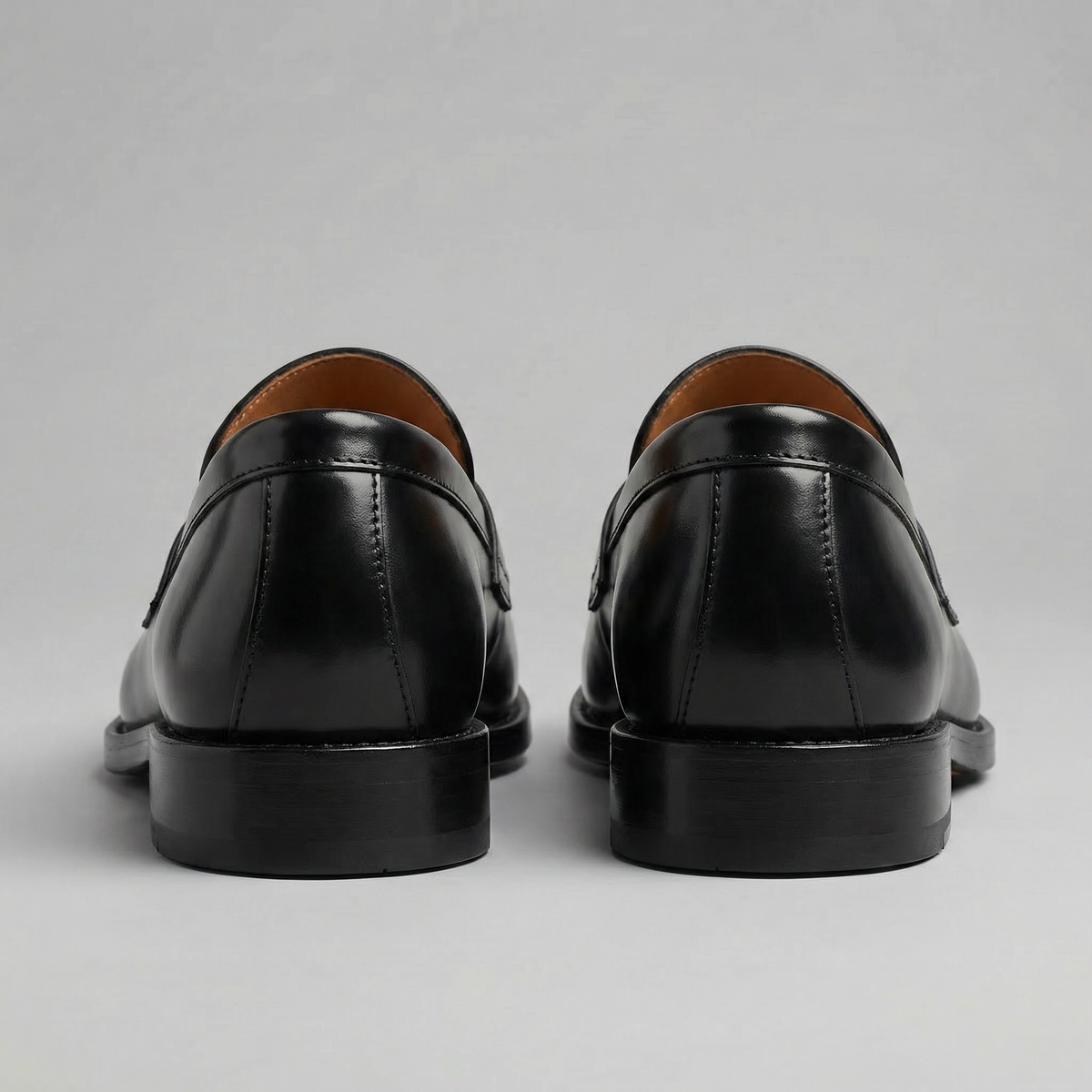 Men's black penny loafers with rounded toes and low heels