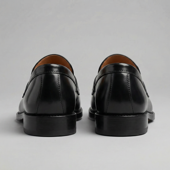 Men's black penny loafers with rounded toes and low heels