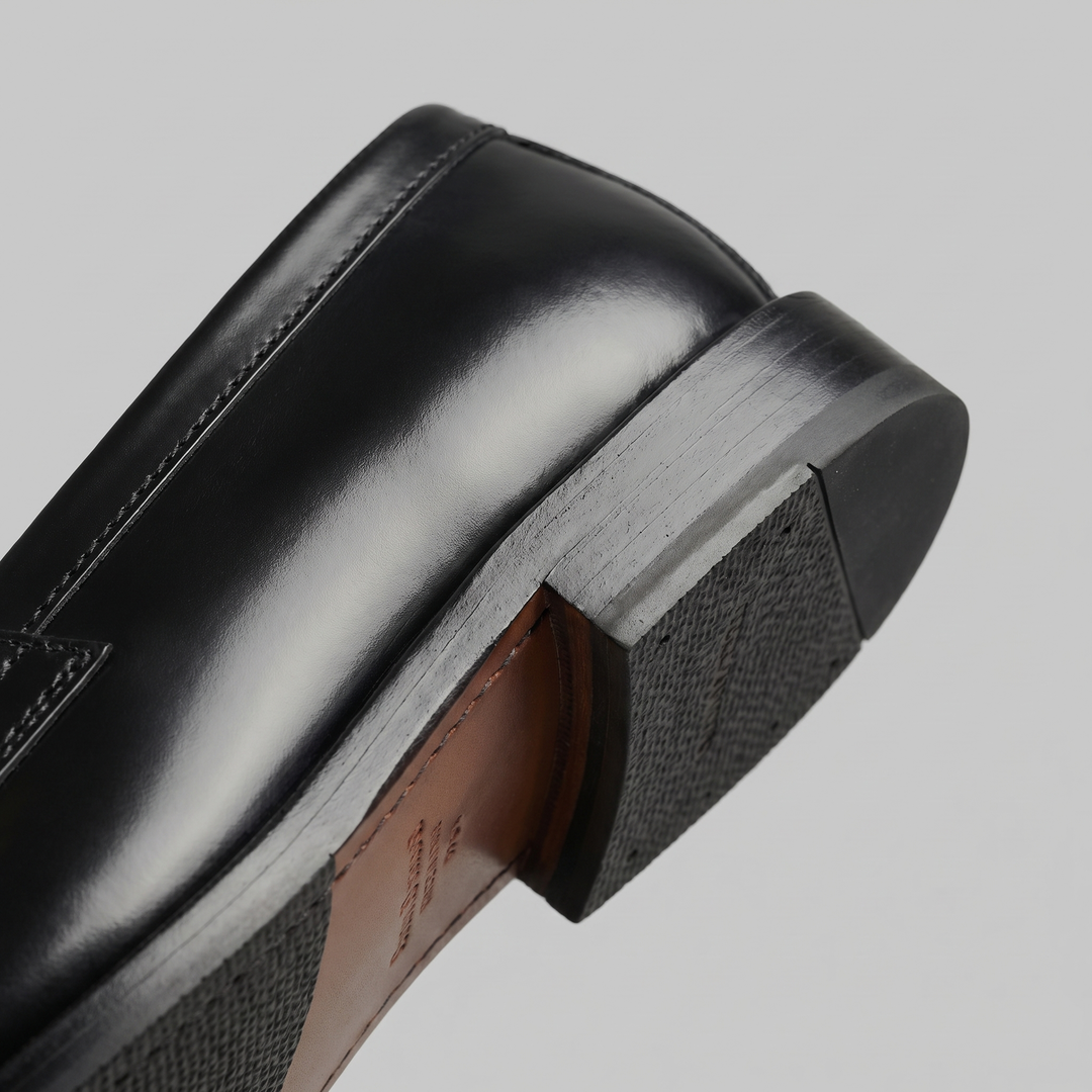 Men's black penny loafers with rounded toes and low heels