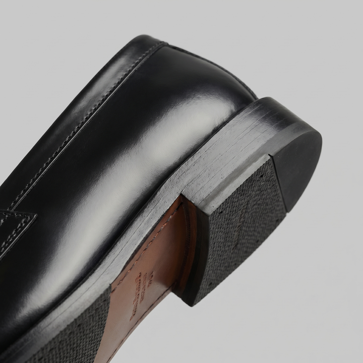 Men's black penny loafers with rounded toes and low heels