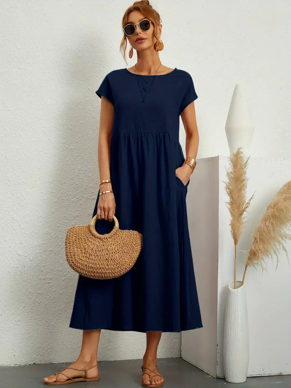 Women's flowing midi dress with round neck and short sleeves, shown in white and navy
