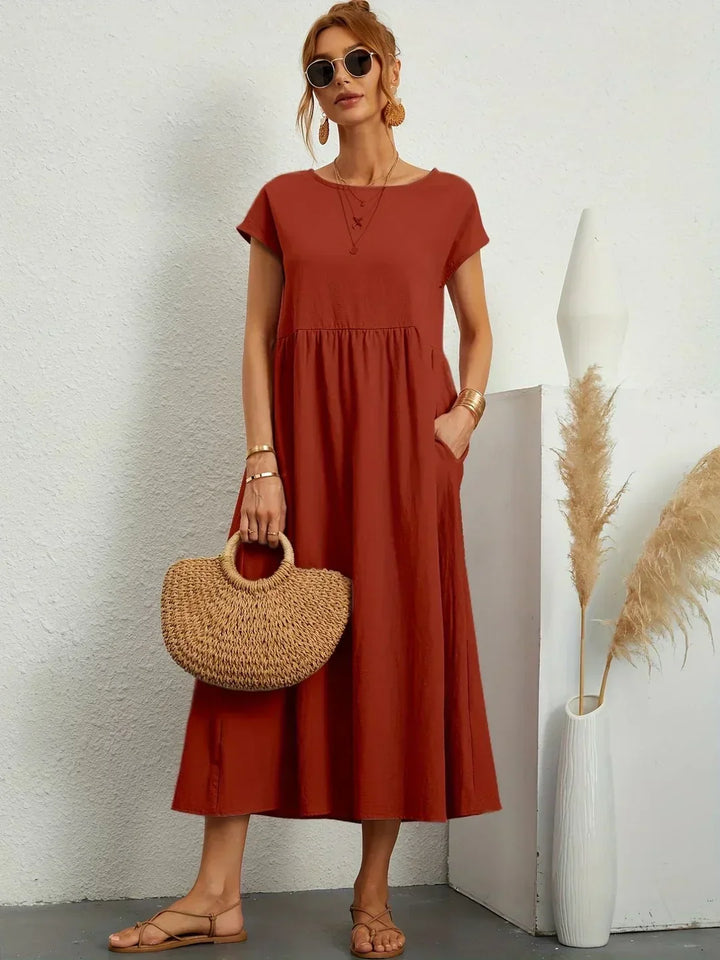 Women's flowing midi dress with round neck and short sleeves, shown in white and navy