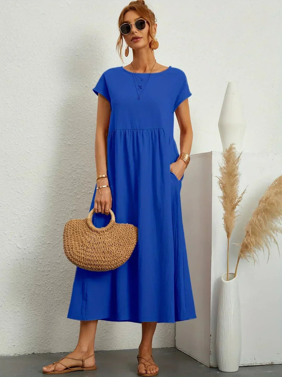 Women's flowing midi dress with round neck and short sleeves, shown in white and navy