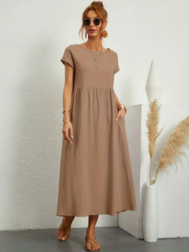 Women's flowing midi dress with round neck and short sleeves, shown in white and navy