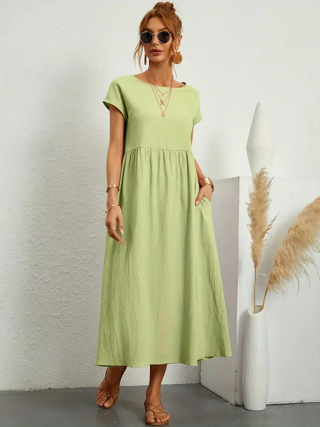 Women's flowing midi dress with round neck and short sleeves, shown in white and navy