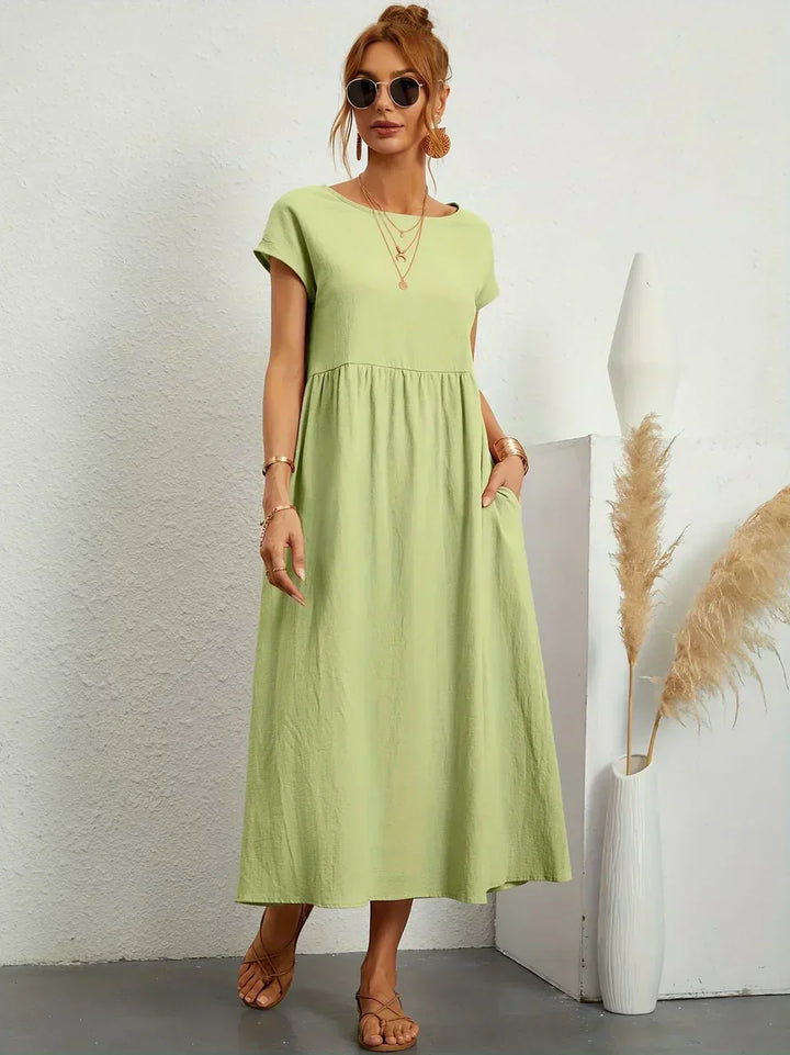 Women's flowing midi dress with round neck and short sleeves, shown in white and navy
