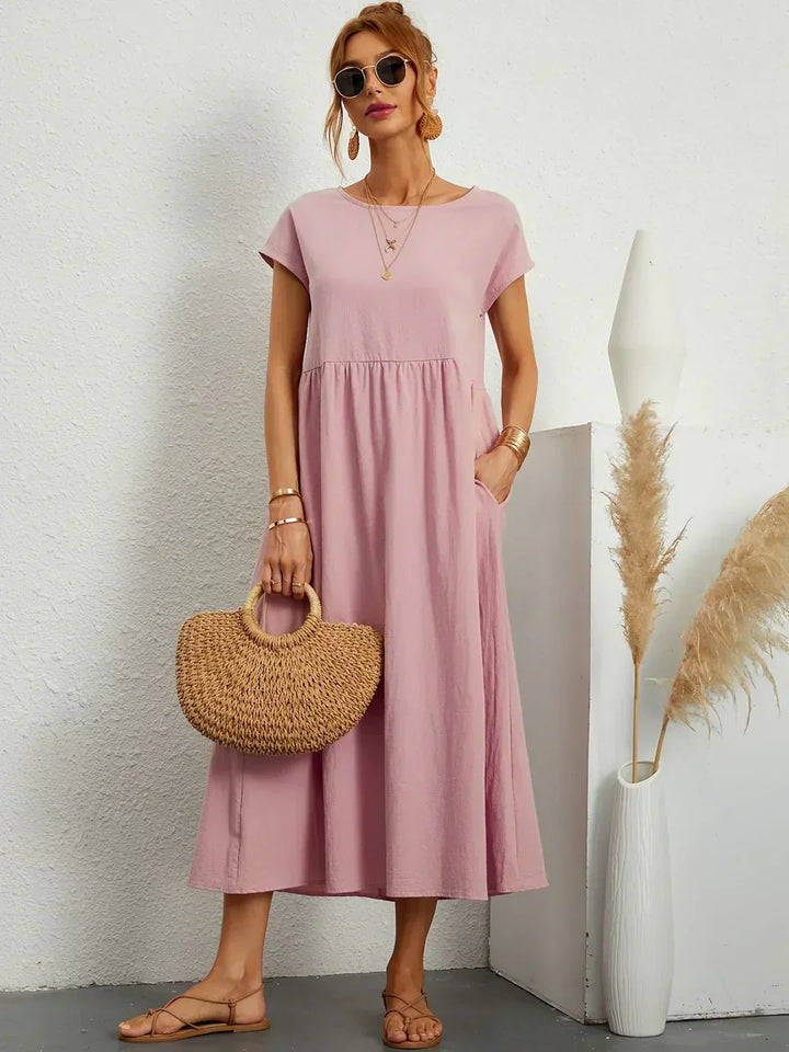 Women's flowing midi dress with round neck and short sleeves, shown in white and navy