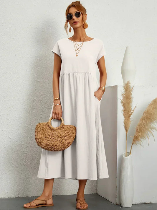 Women's flowing midi dress with round neck and short sleeves, shown in white and navy