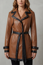 Women's brown belted trench coat with black contrast trim and long sleeves