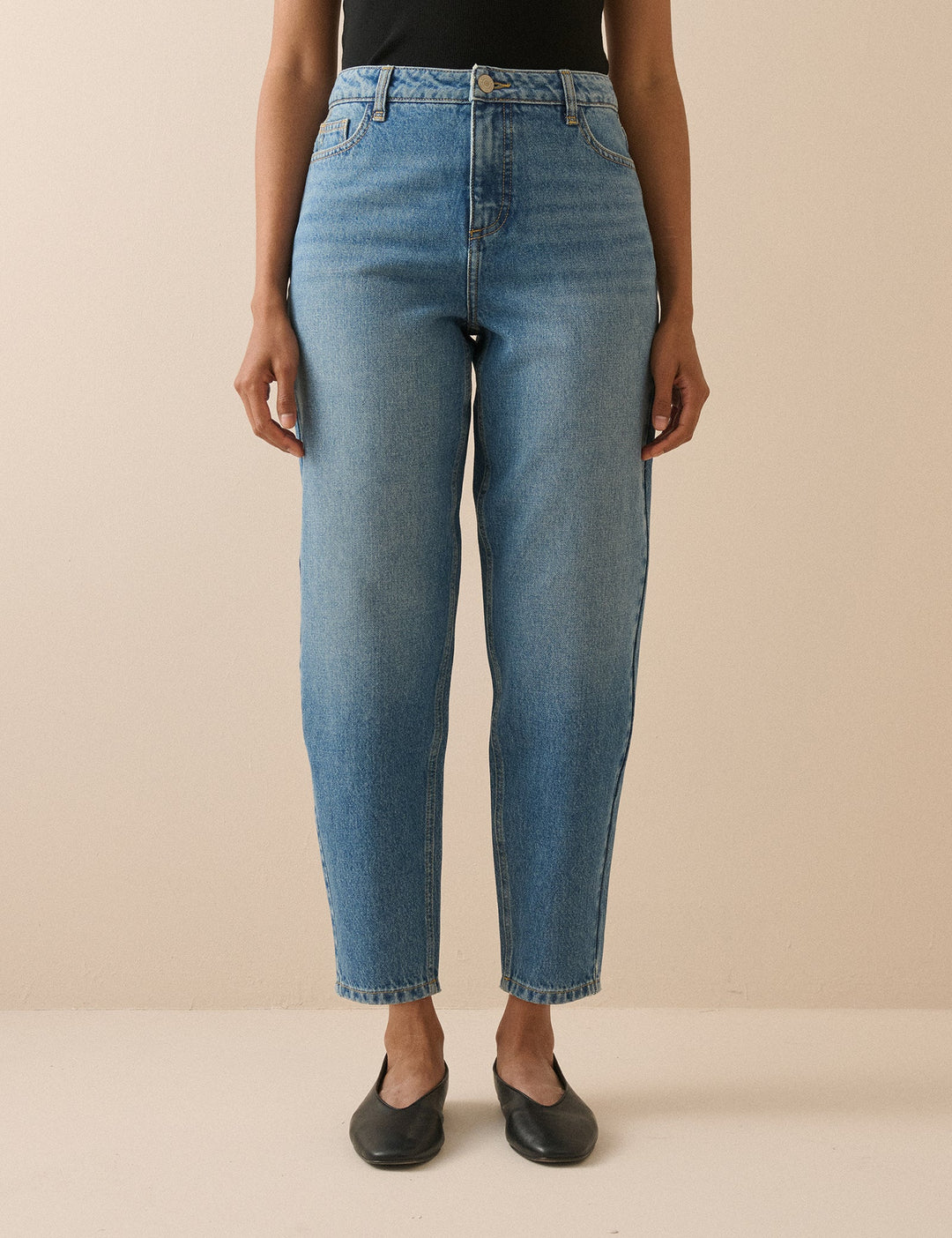 Women's blue barrel leg jeans with high-rise waist and cropped ankle-length hems