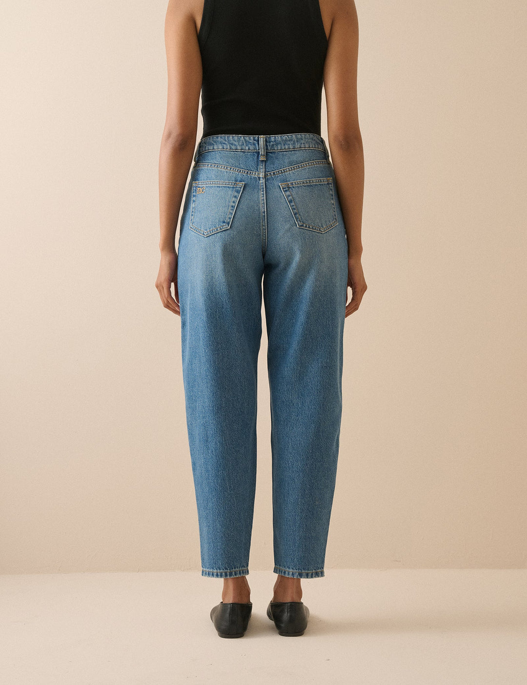 Women's blue barrel leg jeans with high-rise waist and cropped ankle-length hems