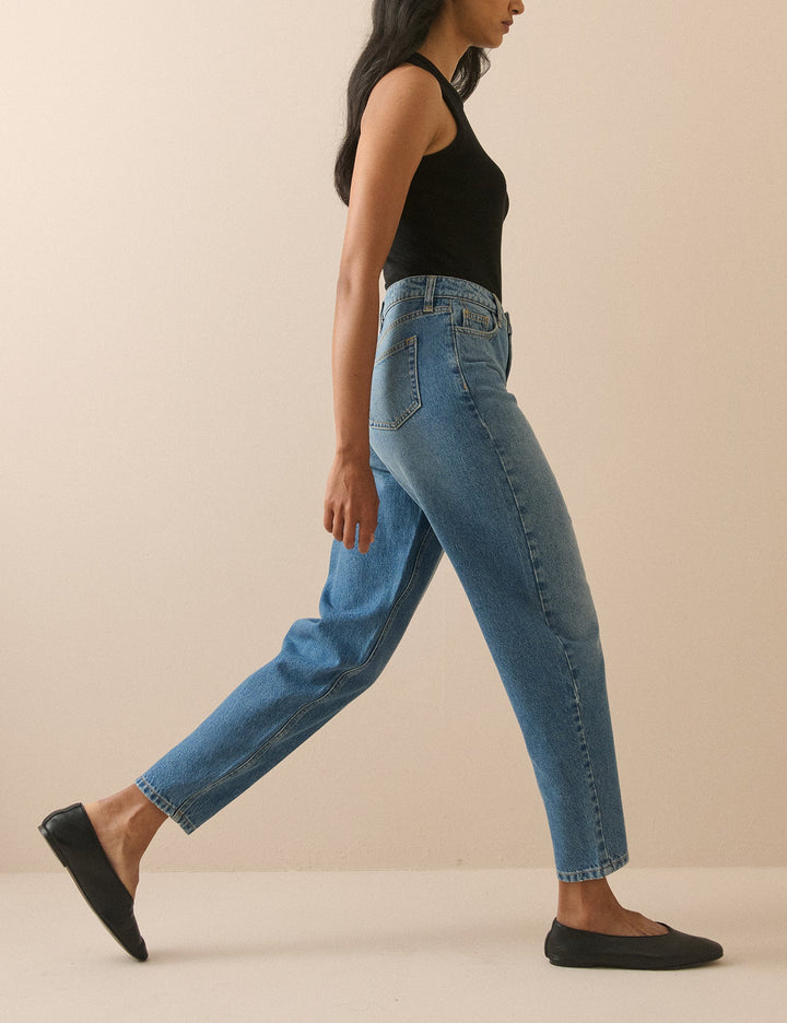 Women's blue barrel leg jeans with high-rise waist and cropped ankle-length hems