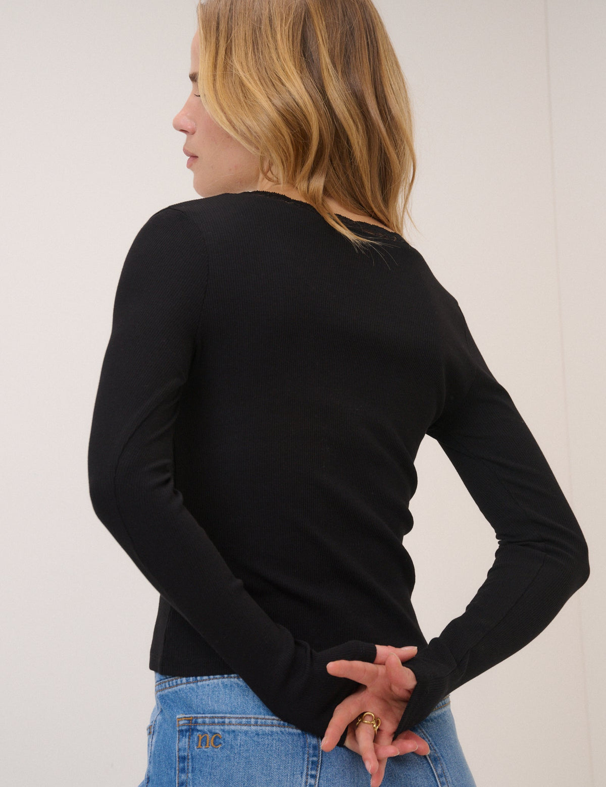 Women's black ribbed cardigan with lace-trimmed V-neckline and front buttons