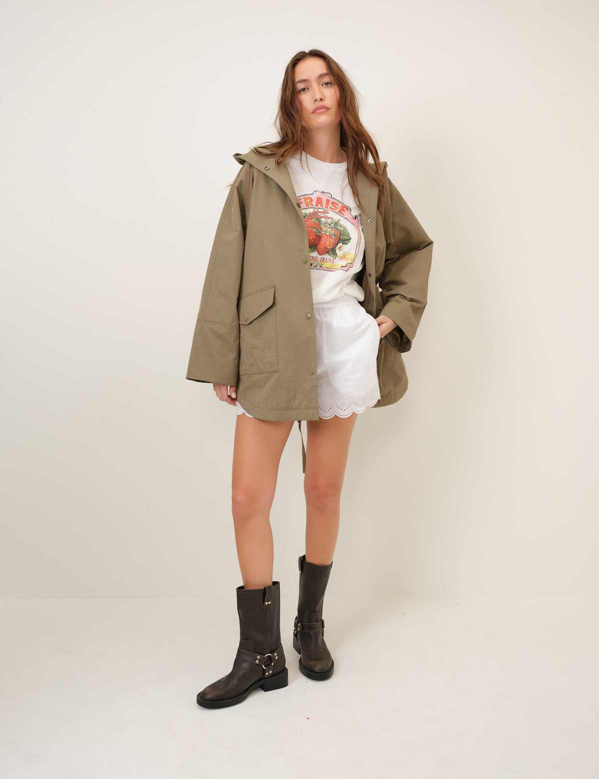 Women's olive green hooded parka jacket with long sleeves and utility pockets